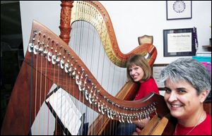 Denise Grupp-Verbon, front, and Jennifer Meehan will perform tomorrow with other harpists, part of Harp Week at Oewns College. Northwest Ohio has had a chapter of the Harp Society since the 1970s.