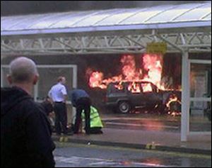 Flames rise from a Jeep after the SUV was rammed into the main terminal of Glasgow airport on Saturday.