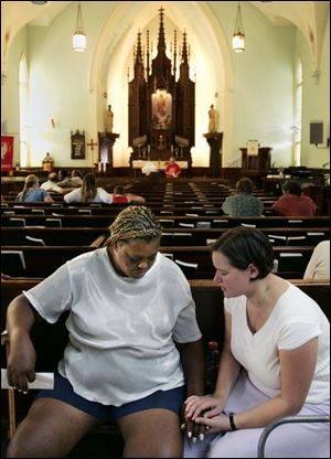 Cheryl Jeffries, left, prays with pastoral intern Abby D Ambruoso at Salem Lutheran Church.