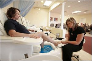Judy Roepke relaxes as Mandy Highley gives her pedicure.
