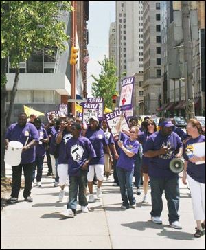 Union members march on Madison Avenue to support wages in line with those in other cities.