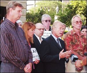 Attorney Jeff Anderson, center, fi led a lawsuit in 2002 on behalf of Harold Lee, left, and George Keller, right, who were
abused as children by Father Leo Welch when the priest served at Immaculate Conception Church in Bellevue, Ohio.
