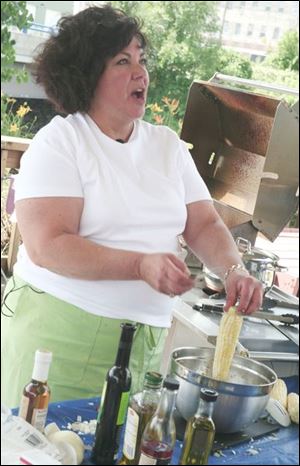 Diane Rogers shows her method of cooking sweet corn to
make a summer corn salad. For corn on the cob, she advises baking the corn in an oven, silks removed but not the husks.

