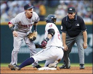 Red Sox second baseman Dustin Pedroia yelps after being spiked by the Indians' Ryan Garko sliding into second on a double.