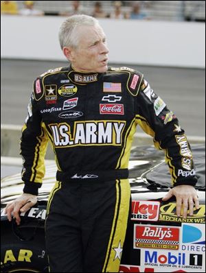 Driver Mark Martin whiles away the time yesterday while waiting to qualify for today s Allstate 400 in Indianapolis.