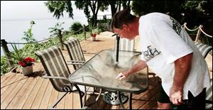 Bolles Harbor s Bob Rosenberger checks out the unusual powder that fell in the community Monday night. 
