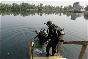 Jeff King, left, and Dan Claybaugh, residents of Lakeview, Ohio, prepare for their dive at the 14-acre Gilboa Quarry. 
