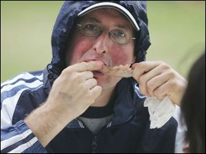 CTY ribs06p  FEA ribs04p   John Layman, of Holland, said he was out of town until Sunday, so he and a friend came today to the rib fest.  Columbia Gas Ribs on the River on a rainy Sunday in Toledo,  Ohio on August 5, 2007. The Blade/Jetta Fraser.