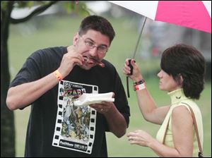 CTY ribs06p  FEA ribs04p   John, left, and Veronica Galatocki, of Toledo, are undeterred by the rain. Columbia Gas Ribs on the River on a rainy Sunday in Toledo,  Ohio on August 5, 2007. The Blade/Jetta Fraser.