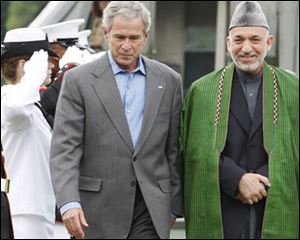 President Bush walks with Afghanistan's President Hamid Karzai at Camp David, Md.