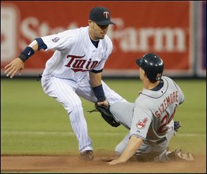 Grady Sizemore, one of the few Indians to reach base, is tagged out by Twins shortstop Jason Bartlett on a steal attempt.