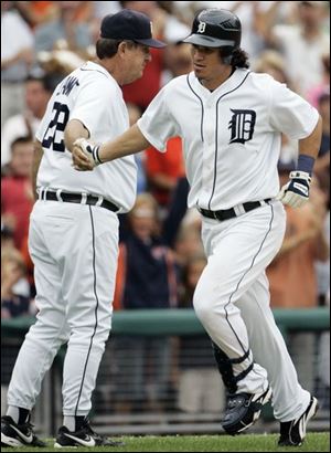 Detroit s Magglio Ordonez is congratulated by Tigers third base coach Gene Lamont after homering in the 8th inning.
