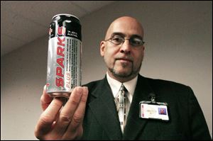Probation officer Johnny Carrillo displays an alcohol-containing
energy drink confiscated from a teen on probation.