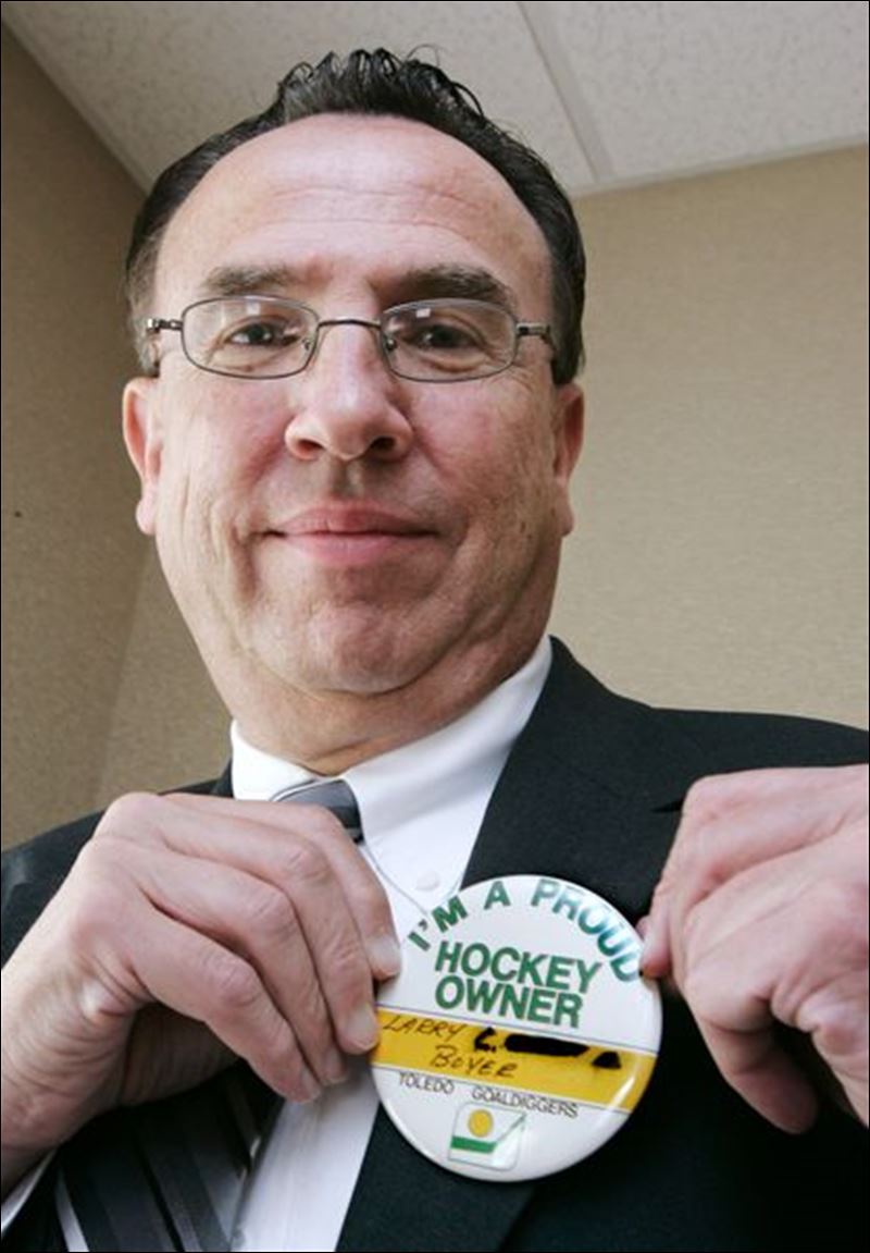 <b>Larry Boyer</b> shows off his owner s badge, which bestowed perks like free <b>...</b> - For-Toledo-hockey-owners-of-80s-payback-was-in-fun