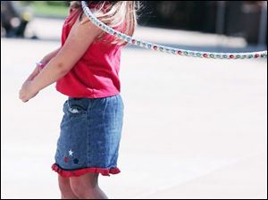 CTY mercy12p 08/10/07 The Blade/Dave Zapotosky Location: Toledo, Ohio Caption: Madison Romick, 5, of Findlay, O., tries a hula hoop which ends up around her neck on an obstacle course sponsored by the Kohl's Kids in Action program during the Mercy Day at the Toledo Zoo.   Summary: Please take photos of children enjoying the 2nd Annual Mercy Day at The Zoo. It is an event that provides games and activities to encourage healthy and safe habits and behaviors. There will be jump roping contests, scavenger hunts, obstacle courses, etc.