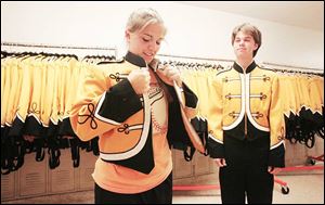 Ali Sayre, 16, left and Brad Bever, 17, try band uniforms on for size at Northview High School. Band camp began last week and will continue though the first day of school on Aug. 23.