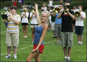 Sara Hennessy, 18, a majorette with the Northview marching band, gives practice a whirl for the upcoming football season. 