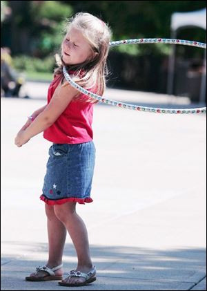 CTY mercy12p 08/10/07 The Blade/Dave Zapotosky Location: Toledo, Ohio Caption: Madison Romick, 5, of Findlay, O., tries a hula hoop which ends up around her neck on an obstacle course sponsored by the Kohl's Kids in Action program during the Mercy Day at the Toledo Zoo.   Summary: Please take photos of children enjoying the 2nd Annual Mercy Day at The Zoo. It is an event that provides games and activities to encourage healthy and safe habits and behaviors. There will be jump roping contests, scavenger hunts, obstacle courses, etc.