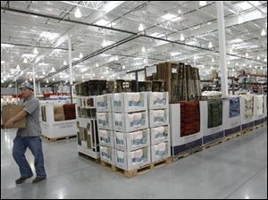 Jeremy Johnson of Gem Inc. is part of the opening crew preparing the Costco Wholesale Club for its opening on Aug. 29. 