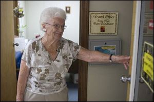 Irene Olsen, 95, who formerly ran a hat shop, oversees the travel department at the Millford, Conn., senior center. 