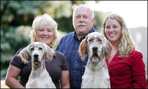 From left, Diane, Terry, and Lindsey Kuhn, of Perrysburg, with English setters Izzy and Logan.