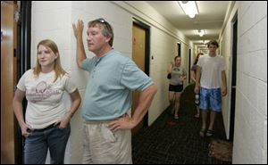 Kristina Karbula, 19, and her father, Mick Karbula of Lexington, Ohio, discuss security features near Ms. Karbula's new dorm room in Dowd Hall at the University of Toledo. 'I was really impressed with the safety here,' Ms. Karbula said.