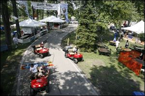 Workers scurry around in carts, making sure all of the booths are fully stocked to serve visitors at the German-American Festival at Oak Shade Grove in Oregon. 