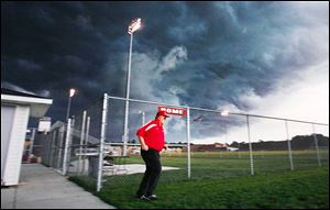 Jim Stover is the last person to leave the field as a storm looms over Rogers High School.
Several area high school football games were affected. 