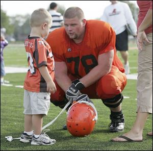 Bowling Green State University s Kory Lichtensteiger is greeted by his son Ayden, 3, after practice.