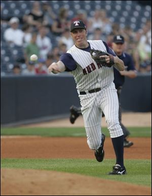 Mud Hens' Mike Hessman makes a throw to first. 