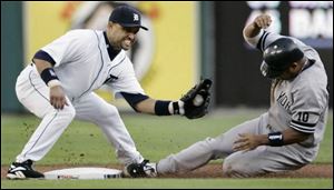 The Yankees  Bobby Abreu beats the tag of the Tigers  Placido Polanco in the first inning of last night s game.