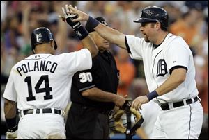 Sean Casey, right, is congratulated by Placido Polanco after scoring on Curtis Granderson's double in the second inning.