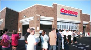 Shoppers wait in anticipation of the bargains inside on Costco s first day at Westgate Village Shopping Center.
