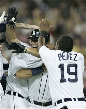 Teammates congratulate Magglio Ordonez after his single in the bottom of the ninth inning scored Curtis Granderson and Placido Polanco to give the Tigers a 5-4 comeback victory.