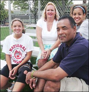 U.S. Army Reserve Maj. Reginald Truss is joined by daughter Katarina, 15, left, his ex-wife Julie, and daughter Kacie, 14. Major Truss, 42, volunteered as a mentor in the Big Brothers program for years. 