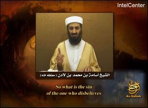This frame grab taken from an undated video message carrying the logo of al-Qaida's production house as-Sahab and provided Tuesday, Sept. 11, 2007 by IntelCenter, a U.S. government contractor monitoring al-Qaida messaging, shows Osama bin Laden raising his finger while speaking. 