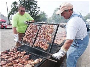 Gene Palmer and Lee Myers man the grilling pit.