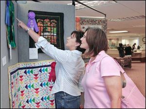  Lisa Crist,left, and Claire Jennings, both of Dundee, admire some of the handiwork.