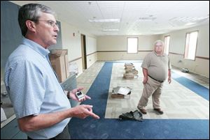 Dennins Jenkins, left, zoning coordinator, and Dennis Steinman, township trustee, examine a classroom in the new structure, which is still under construction.