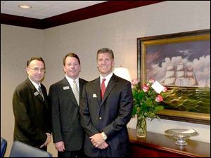Lawrence C. Boyer, left, Michael W. White, and Michael R. Miller celebrate the opening of Waterford Bank.