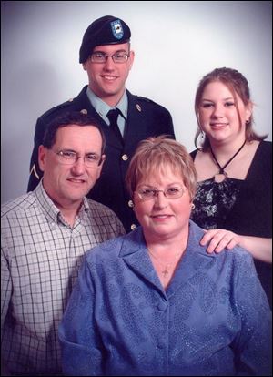 Pfc. Christian M. Neff is shown in a family portrait with his
parents, Bill and Nancy Neff, and sister, Shannon. Private
Neff died of injuries from an improvised explosive device in Baghdad.