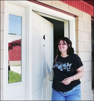 Cheryl Lorton closes the door after touring what will be her new home at Safe Haven on 21st Street downtown.
