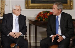 President Bush, right, makes a statement to reporters as Palestinian President Mahmoud Abbas, left, looks on during their meeting on the sidelines of the United Nations General Assembly in New York Monday, Sept. 24, 2007. 