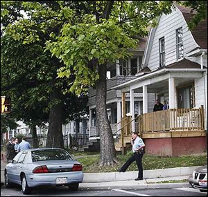 Police, on the scene, investigate the early morning stabbing.