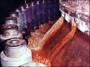 Red, rusty deposits on this nuclear reactor vessel flange were caused by boric acid. Plant officials learned that the acid had burned through everything but a stainless steel liner.