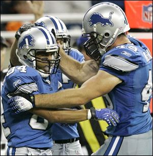 Detroit wide receiver Shaun McDonald, left, celebrates catch ing a four-yard touchdown pass with teammate Sean McHugh.