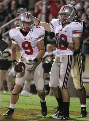 Ohio State wide receiver Brian Hartline, left, is congratulated by Dane Sanzenbacher after scoring a touchdown in the first quarter last night against Purdue.