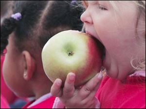 Izzy Klocinski opens wide for a taste.