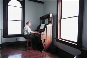 erry Jankowski plays a Reed organ at the church at Wolcott House Museum, as he warms up before performing for a wedding.