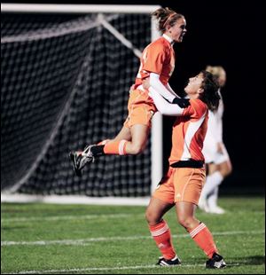 Katie Murphy leaps into the arms of Southview teammate Brooke Nye after scoring a goal against Northview. The Cougars are 5-1-1 in the NLL.